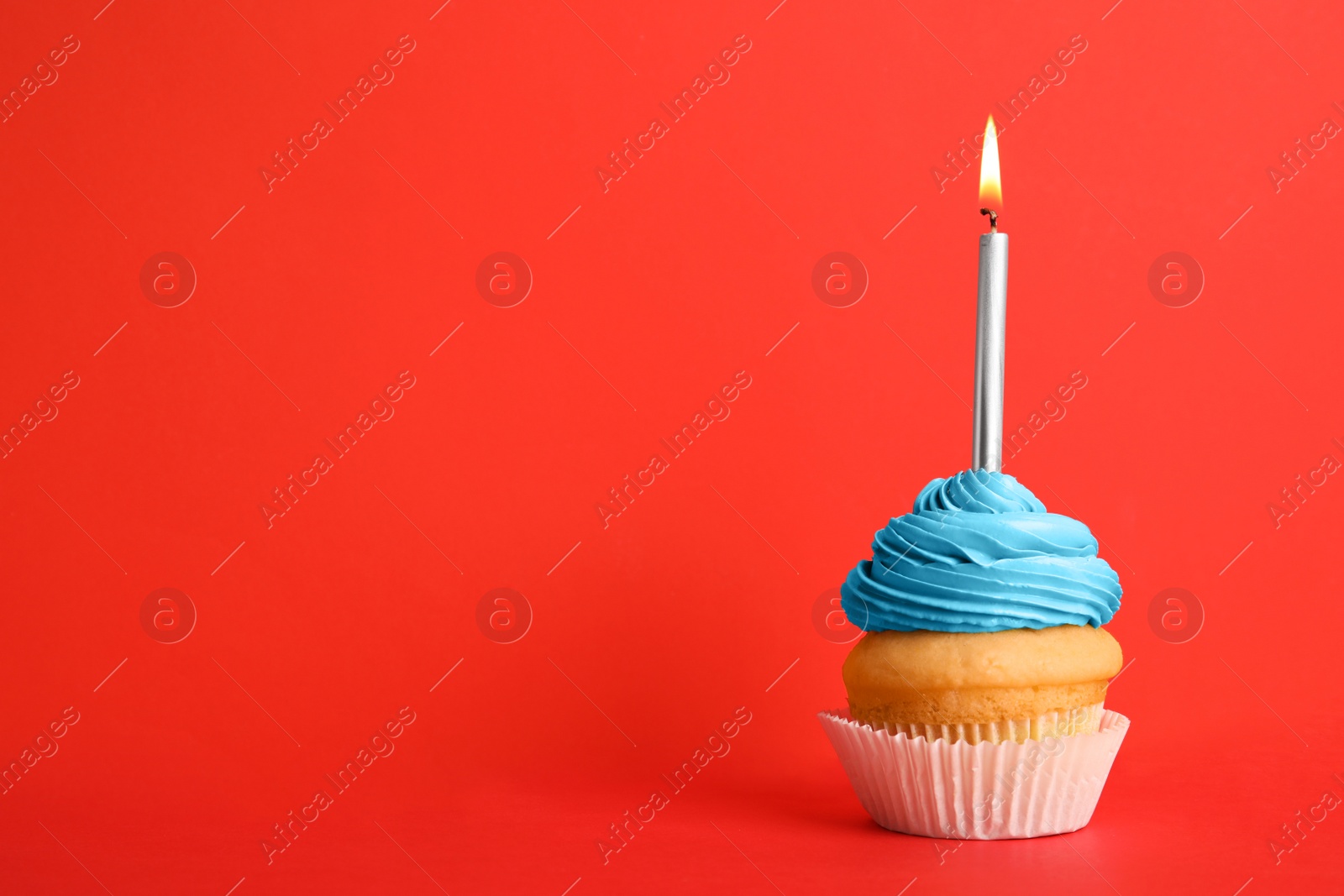 Photo of Birthday cupcake with candle on red background, space for text