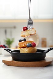 Delicious cottage cheese pancakes with fresh berries and honey served on white table