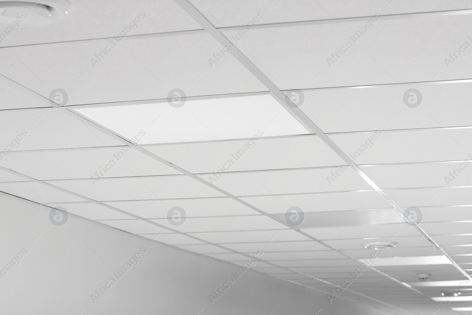 Photo of White ceiling with modern lighting in room