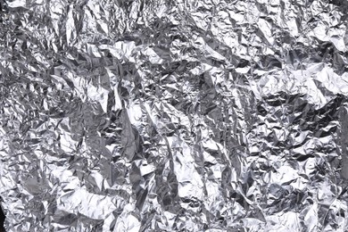 Crumpled silver foil as background, closeup view