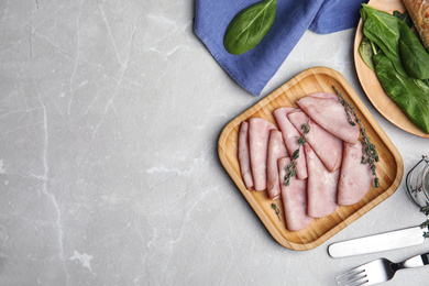 Photo of Tasty ham served on light grey marble table, flat lay. Space for text