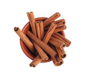 Photo of Dry aromatic cinnamon sticks in bowl isolated on white, top view