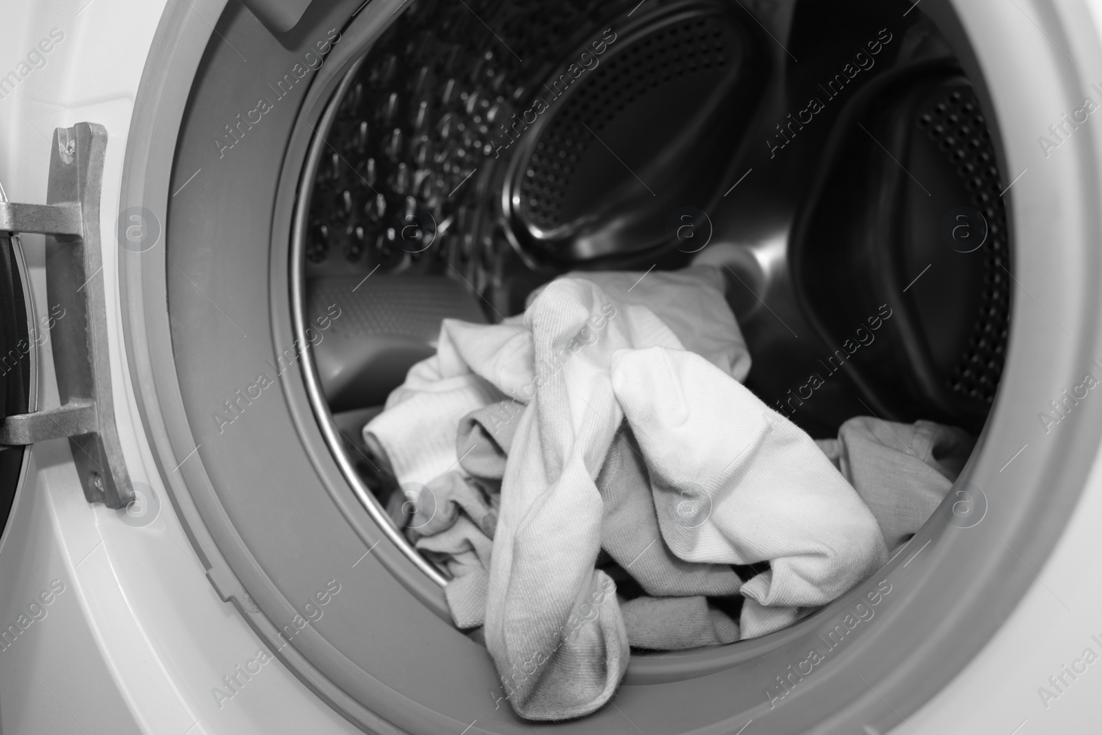 Photo of Many dirty socks in washing machine, closeup