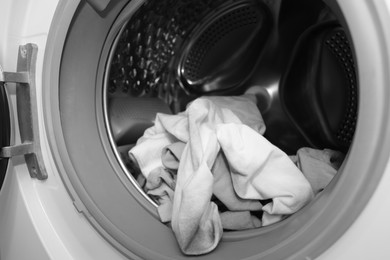 Photo of Many dirty socks in washing machine, closeup