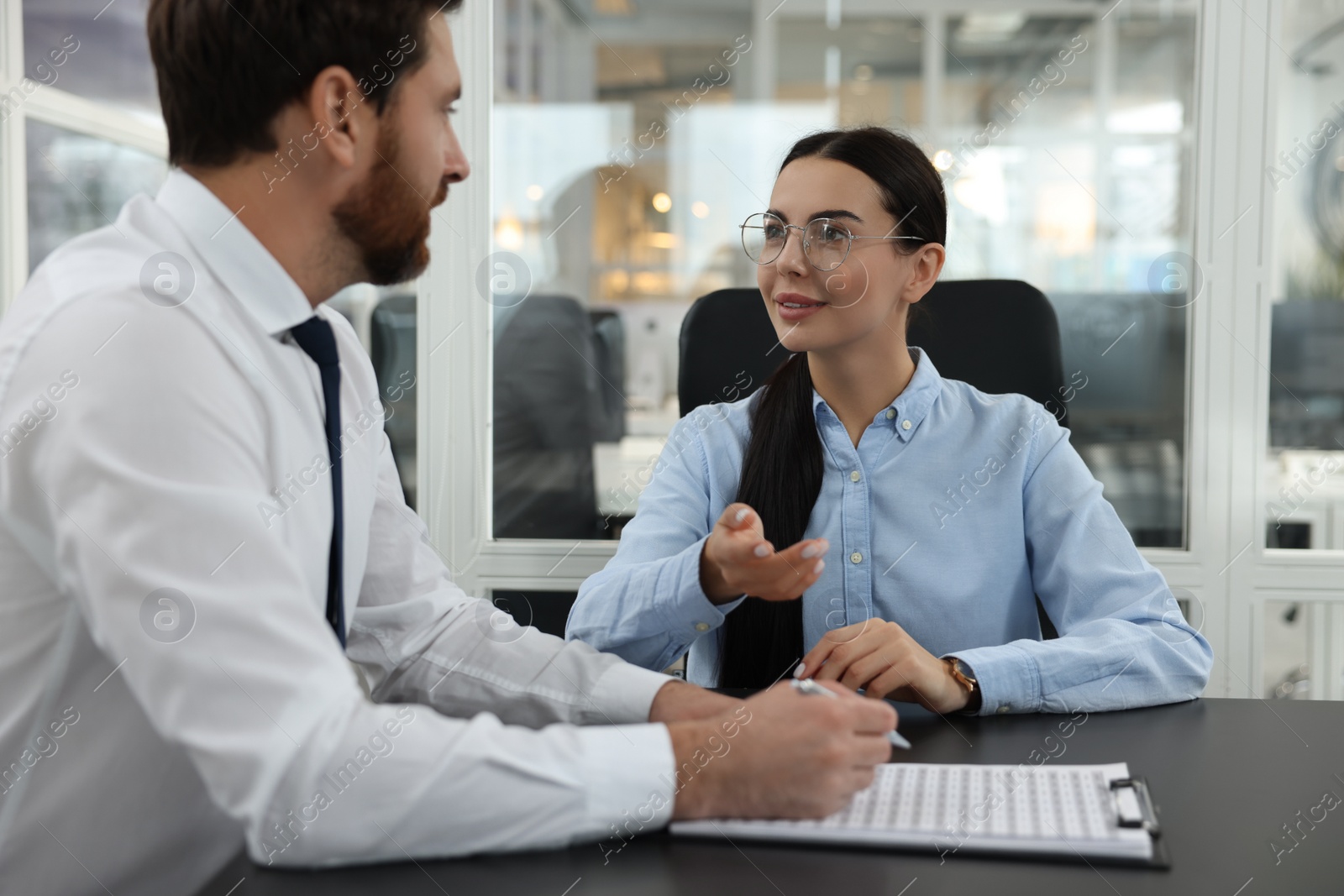 Photo of Lawyers with clipboard working together at table in office