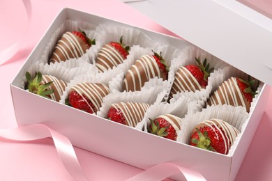 Photo of Box with delicious chocolate covered strawberries on pink background, closeup