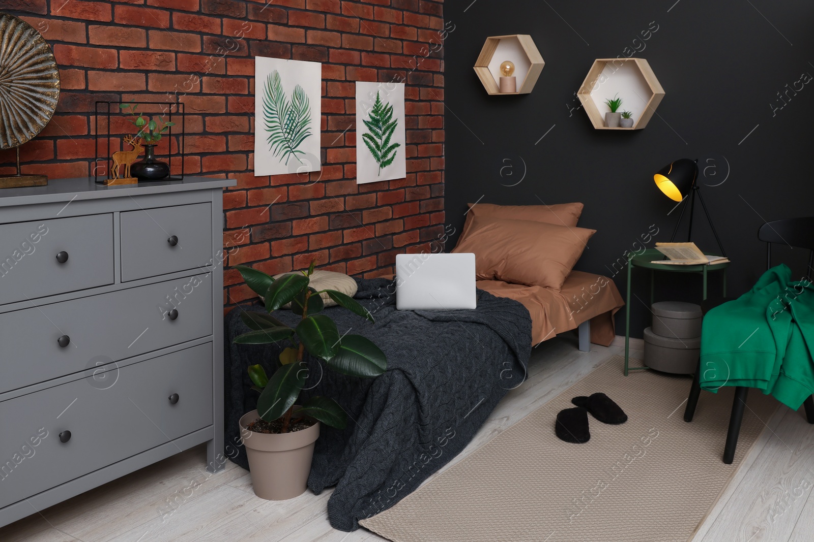 Photo of Stylish teenager's room with laptop, bed and chest of drawers