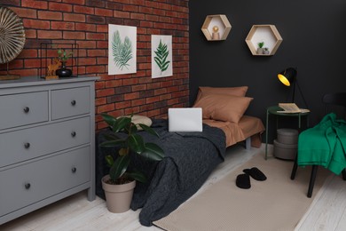 Stylish teenager's room with laptop, bed and chest of drawers