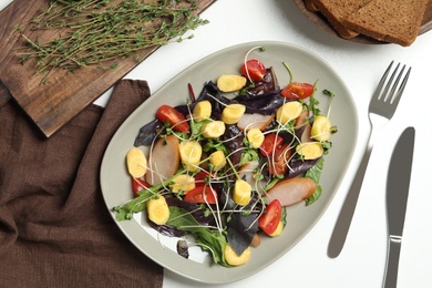 Photo of Delicious fresh carrot salad served on white table, flat lay