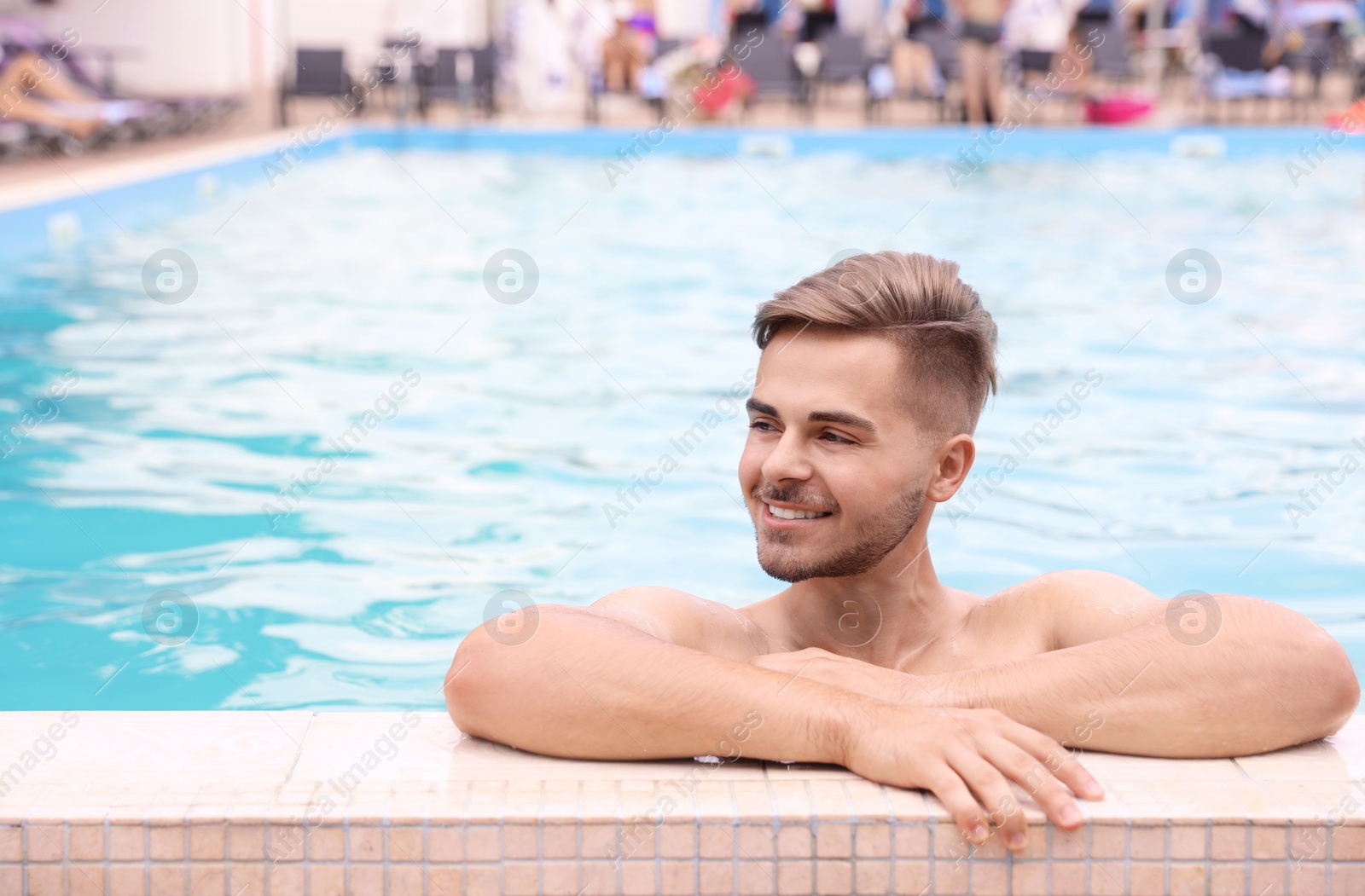 Photo of Young man in pool on sunny day