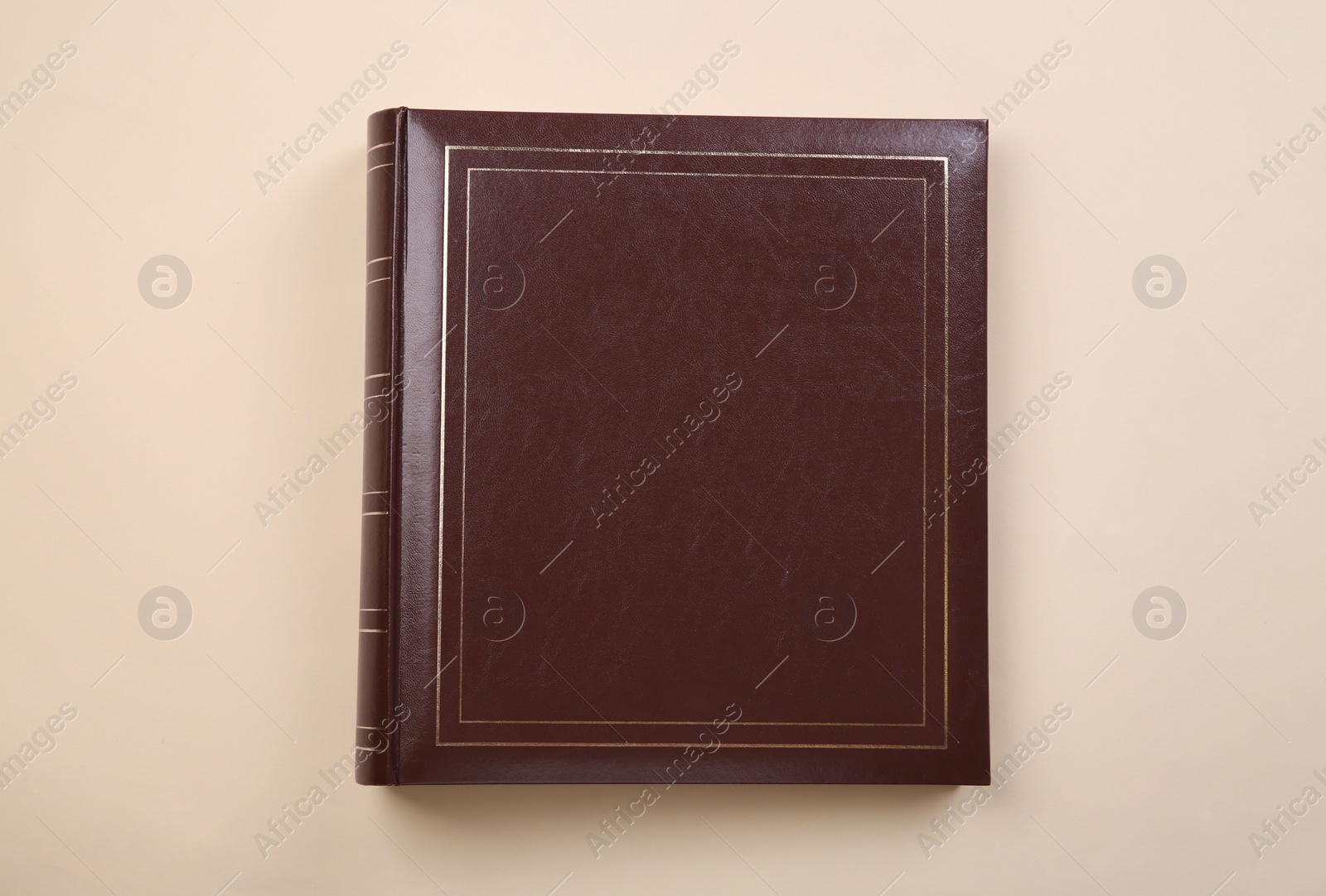 Photo of Photo album with leather cover on beige background, top view