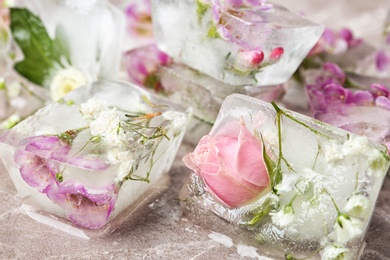 Floral ice cubes on table, closeup view