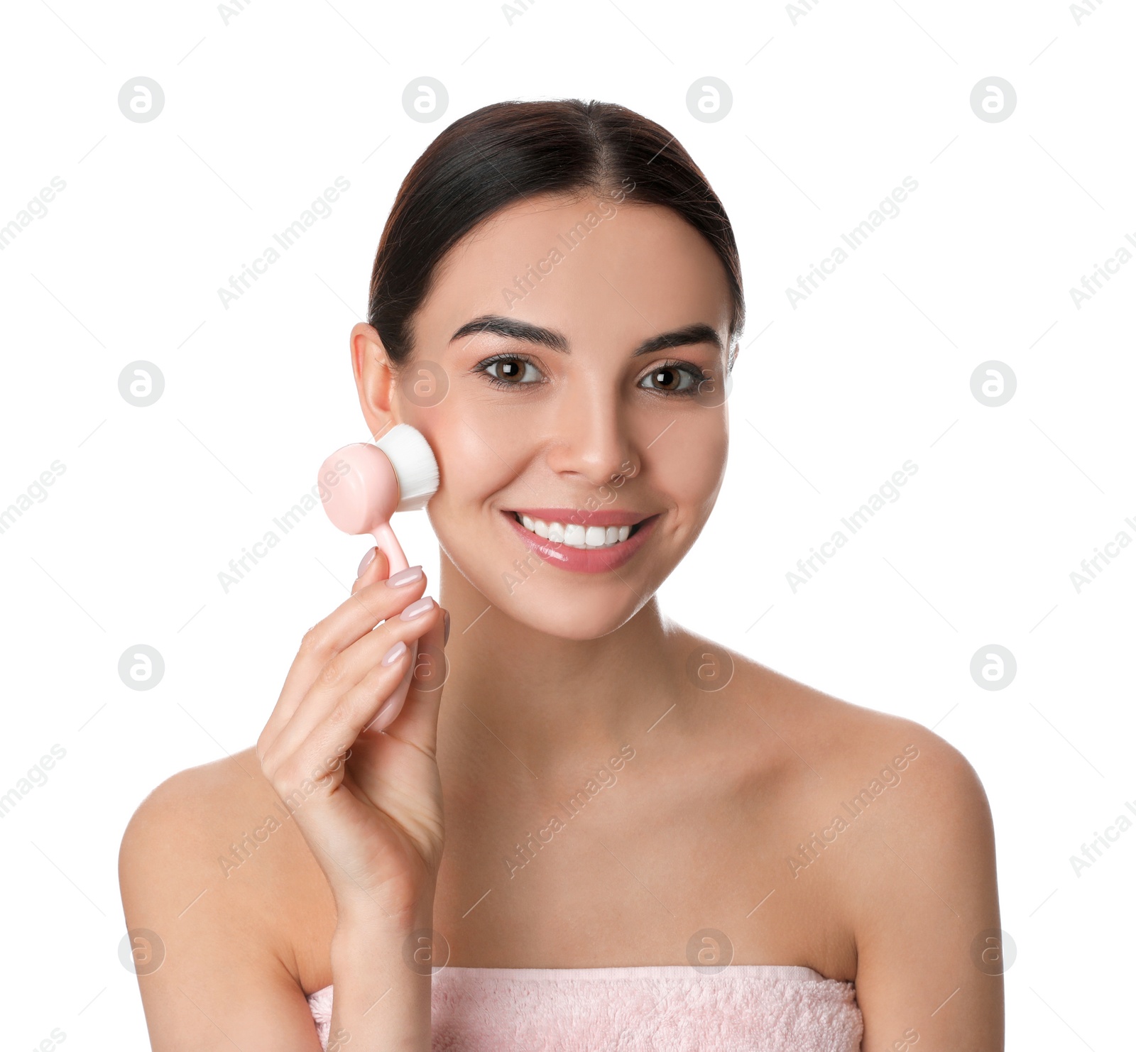 Photo of Young woman using facial cleansing brush on white background. Washing accessory