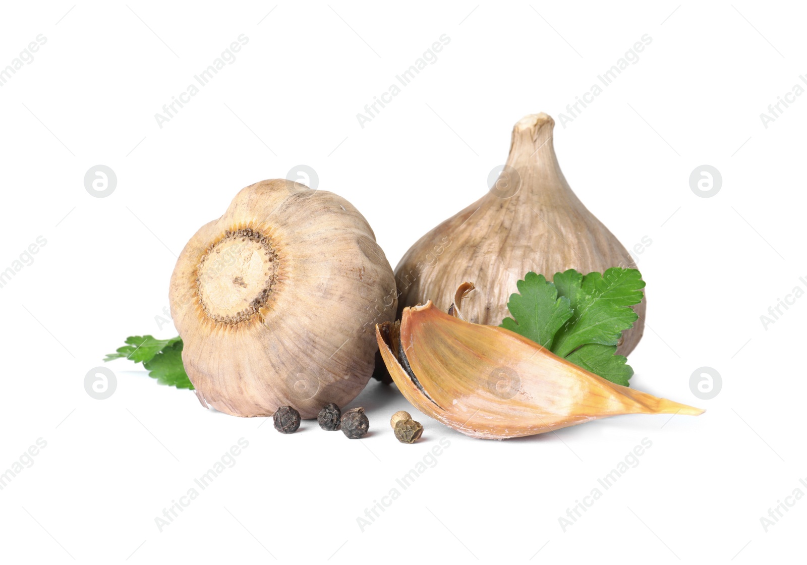 Photo of Aged black garlic with parsley on white background