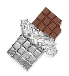 Photo of Bitten milk chocolate bar wrapped in foil isolated on white, top view