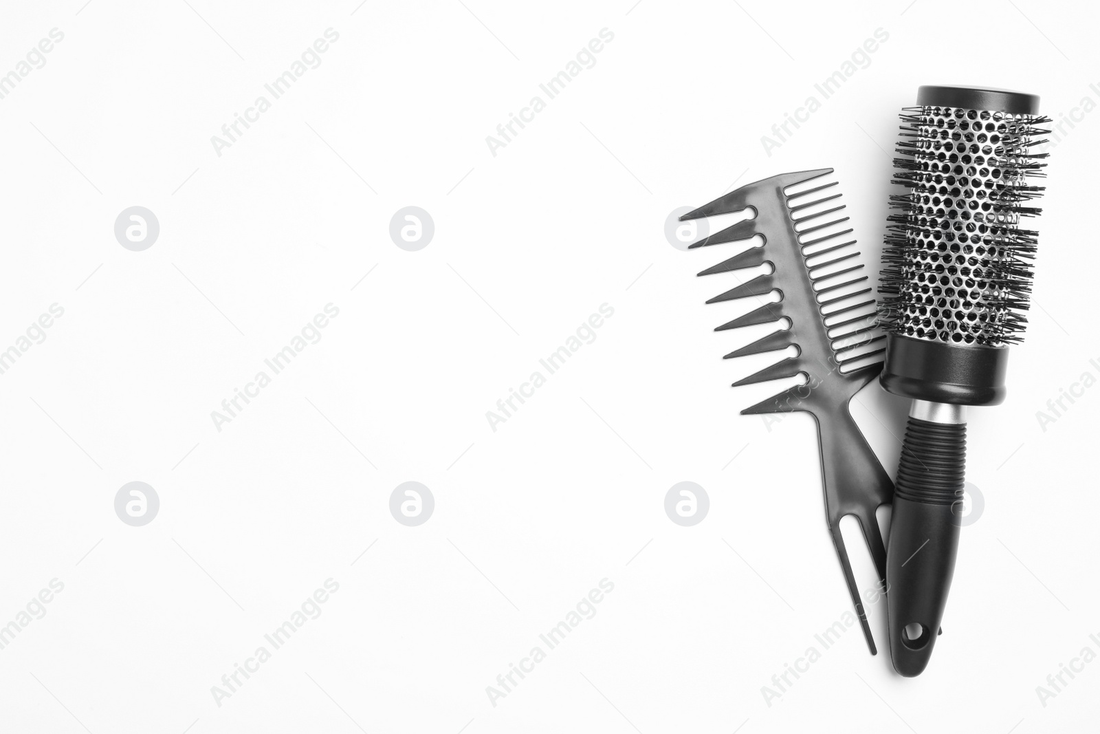 Photo of Modern hair comb and round brush on white background, top view