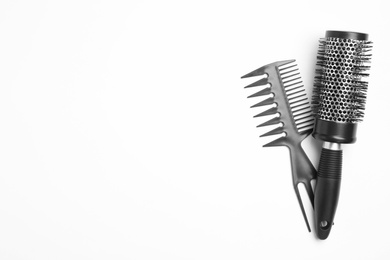 Photo of Modern hair comb and round brush on white background, top view