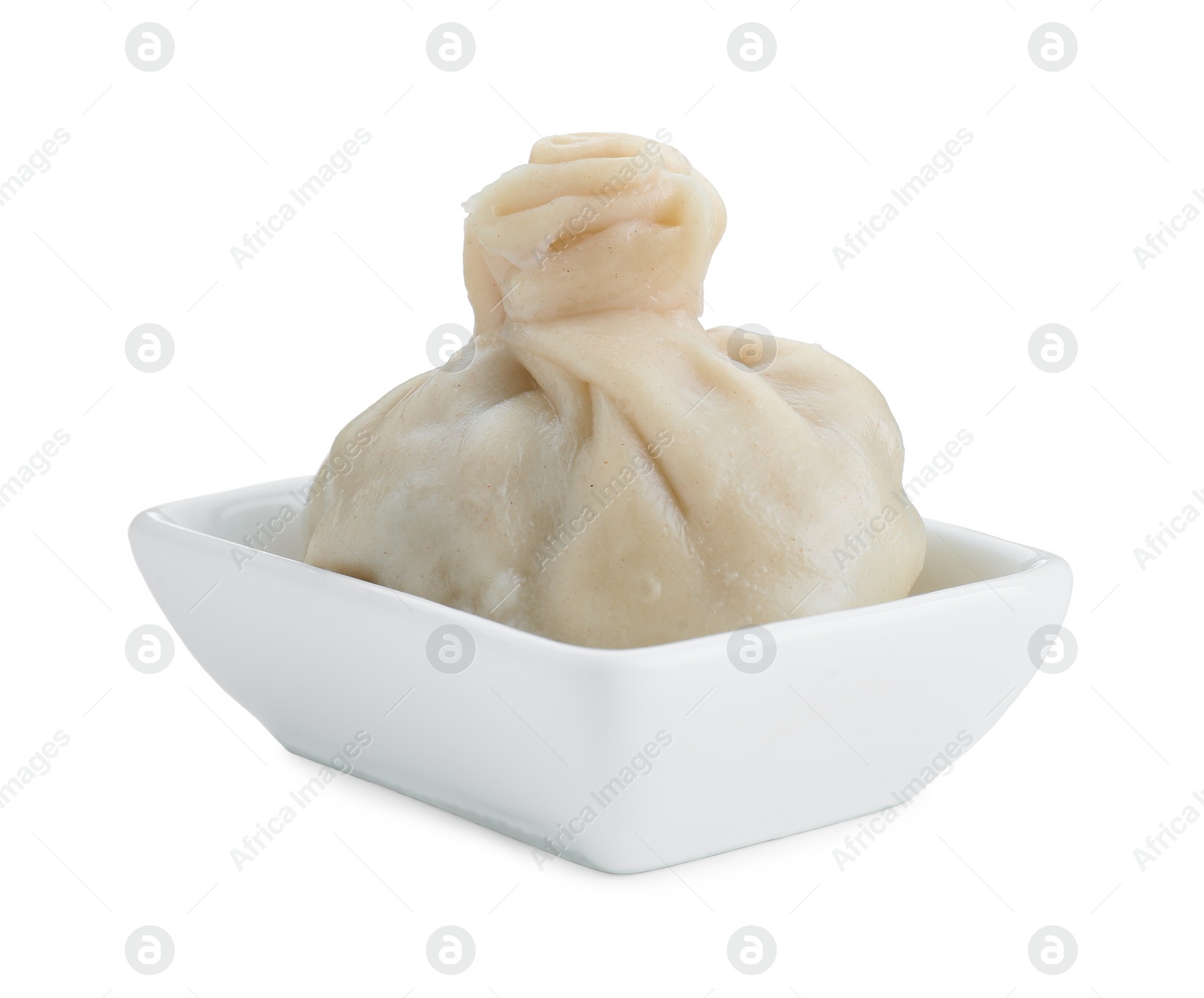 Photo of One tasty khinkali (dumpling) in bowl isolated on white. Georgian cuisine