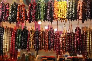 Photo of Bunches of different delicious churchkhelas at market