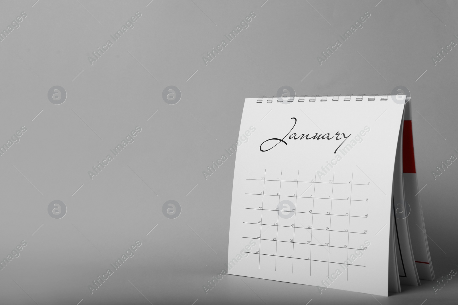 Photo of Paper calendar on grey background, space for text. Planning concept