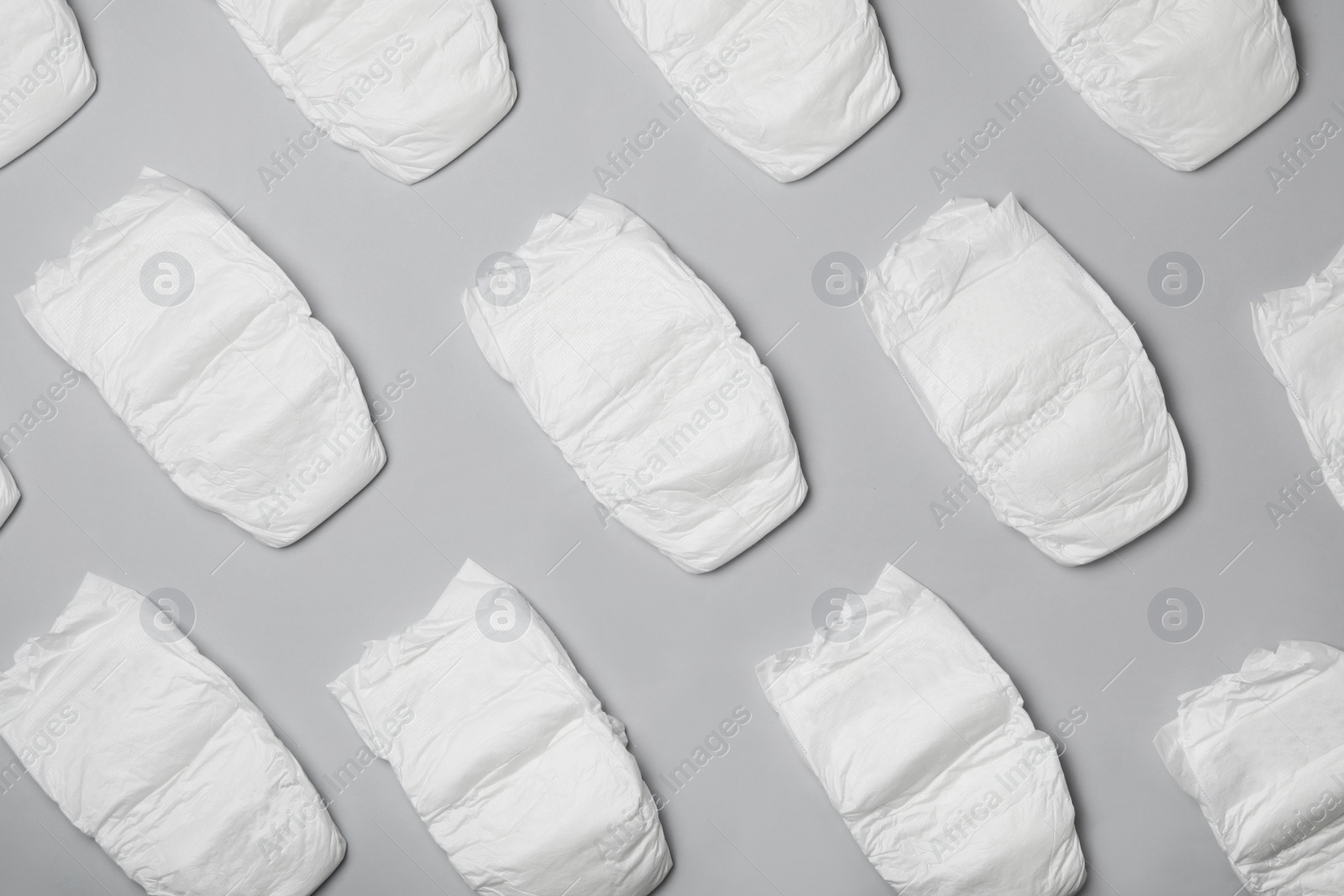 Photo of Flat lay composition with diapers on light grey background