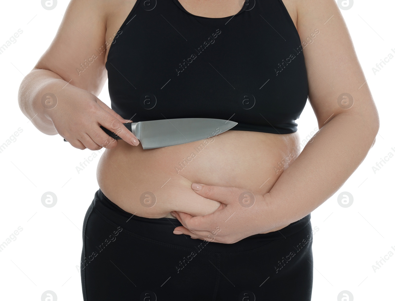 Photo of Obese woman with knife on white background, closeup. Weight loss surgery