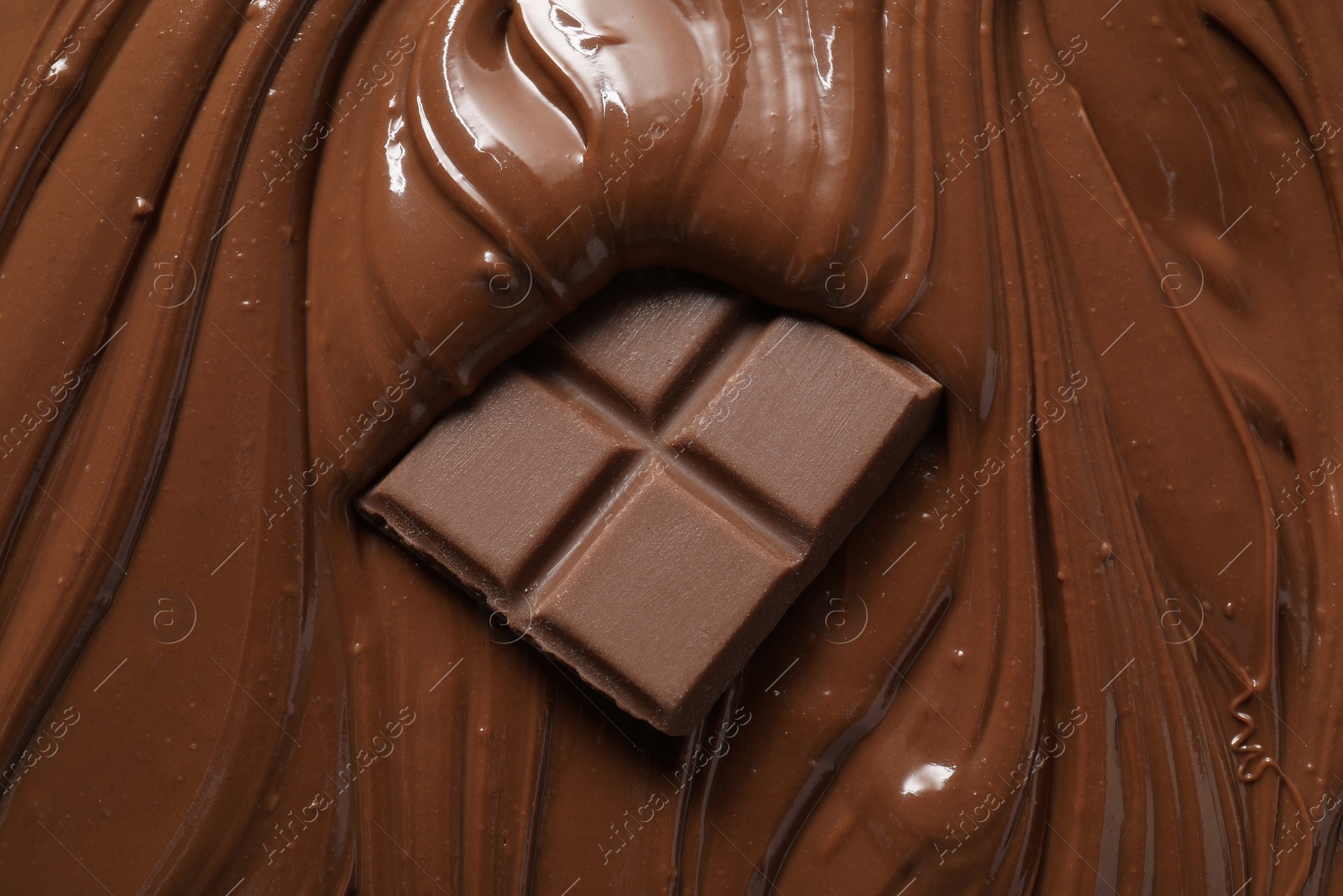 Photo of Tasty milk chocolate paste and pieces as background, top view