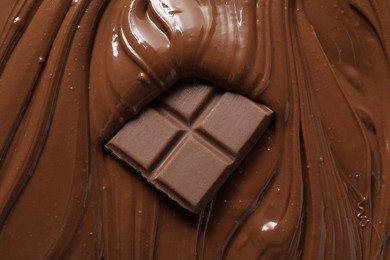 Photo of Tasty milk chocolate paste and pieces as background, top view