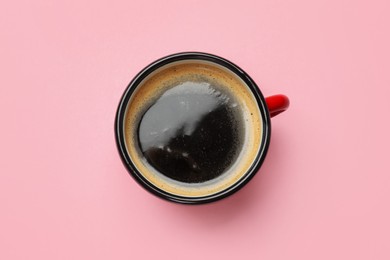 Photo of Fresh coffee in cup on pink background, top view