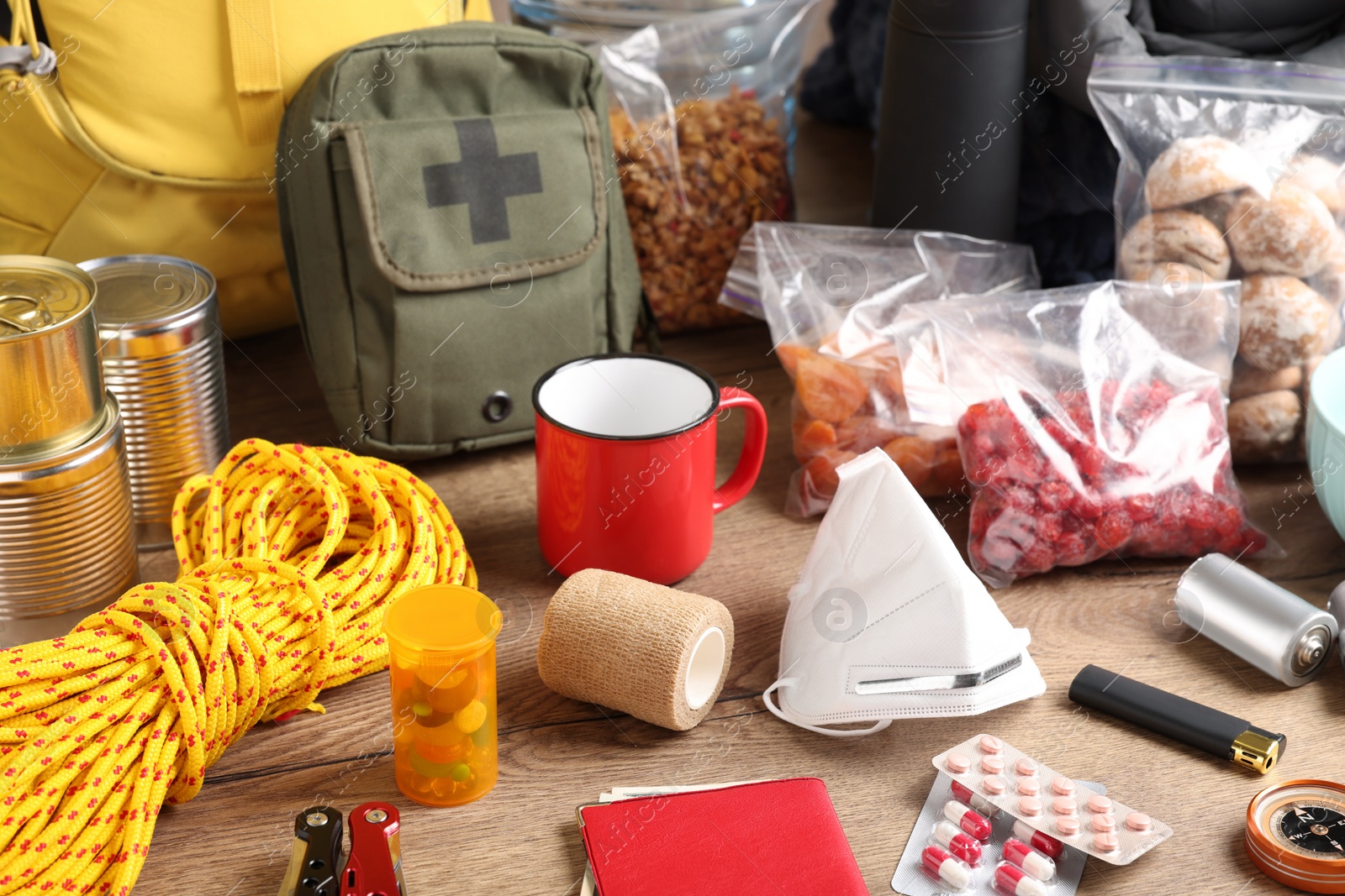 Photo of Disaster supply kit for earthquake on wooden table