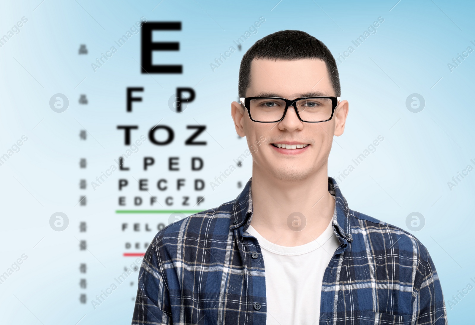 Image of Vision test. Man in glasses and eye chart on light blue background