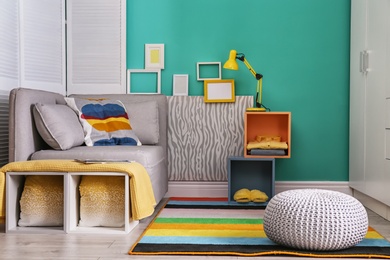 Elegant living room interior with comfortable sofa. Home design in rainbow colors