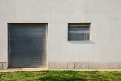 Building exterior with roller shutter door and grated window