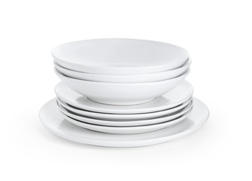 Stack of beautiful ceramic plates and bowls isolated on white