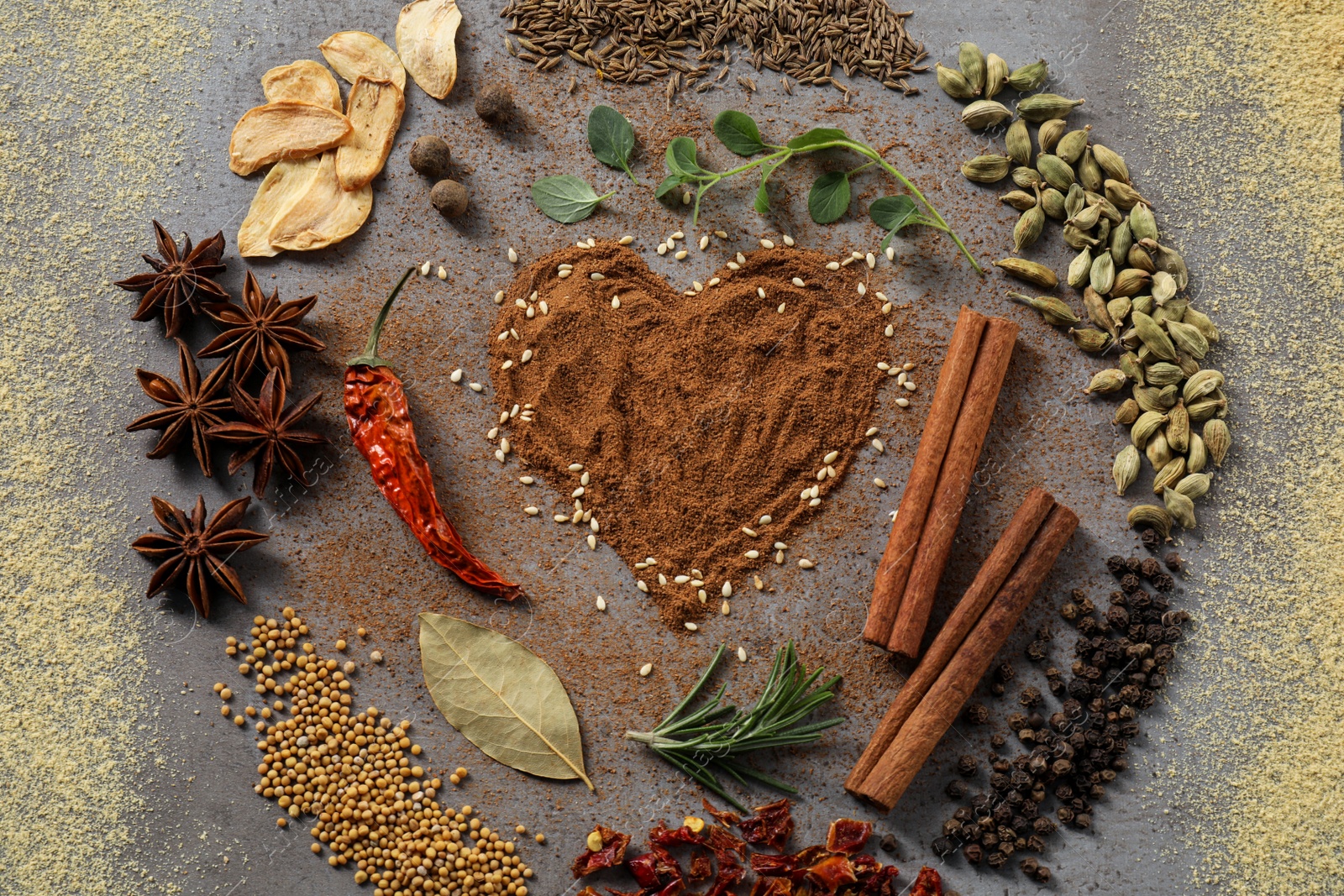 Photo of Flat lay composition of different spices on grey textured table