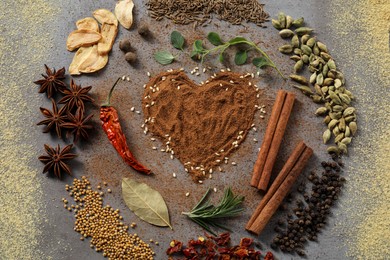 Flat lay composition of different spices on grey textured table