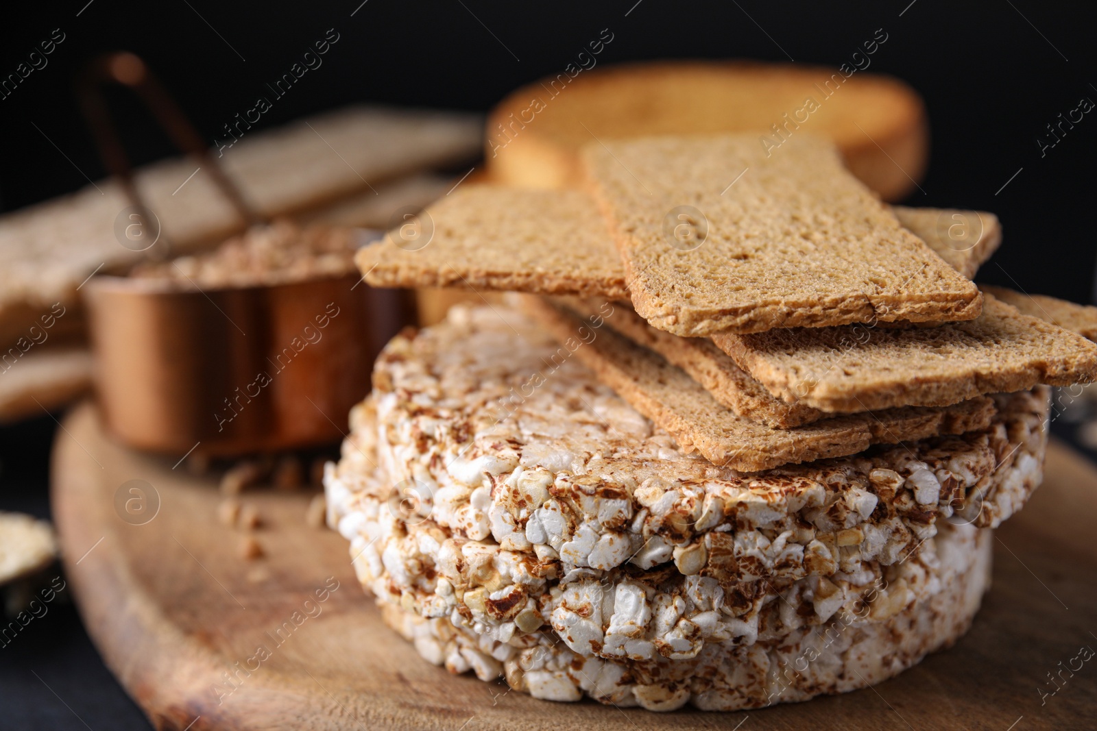 Photo of Rye crispbreads, rice cakes and rusks on table, closeup