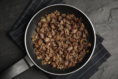 Photo of Fried minced meat with onion on black table, top view