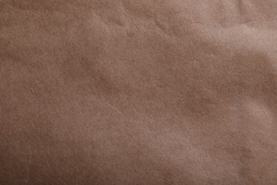 Photo of Texture of kraft paper bag as background, closeup