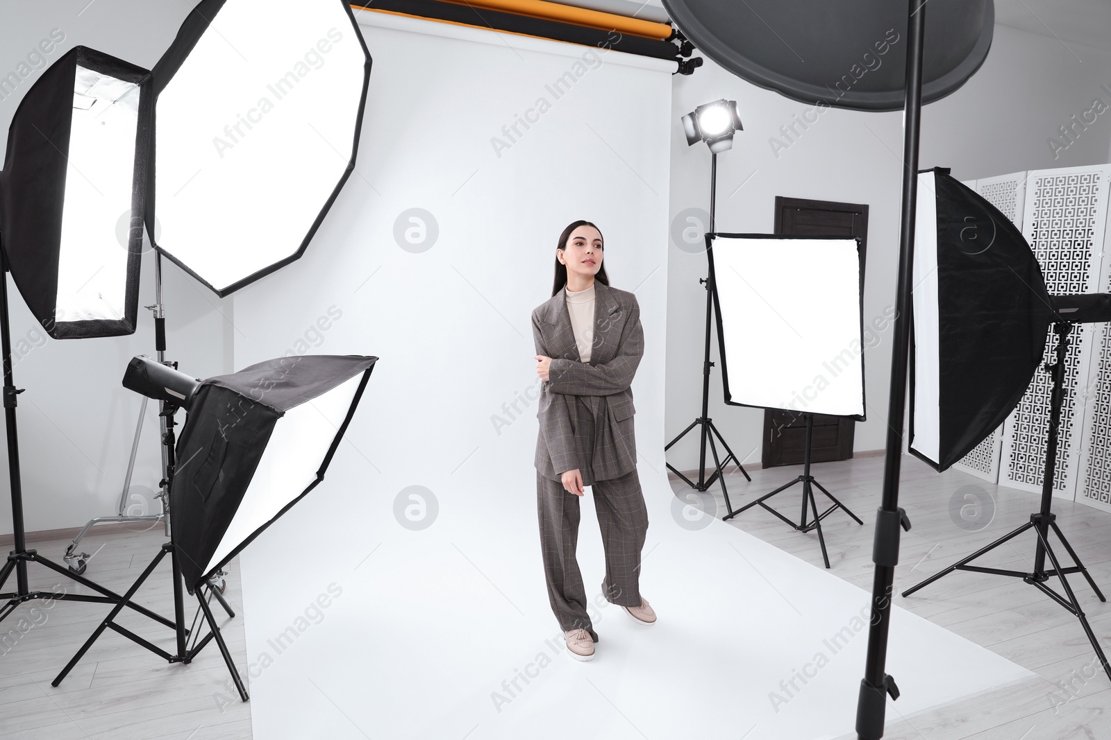 Photo of Beautiful young model posing in modern studio. Professional photo session