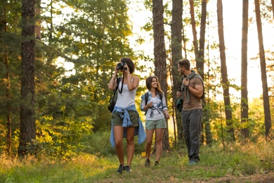 Young friends in forest on summer day. Camping season