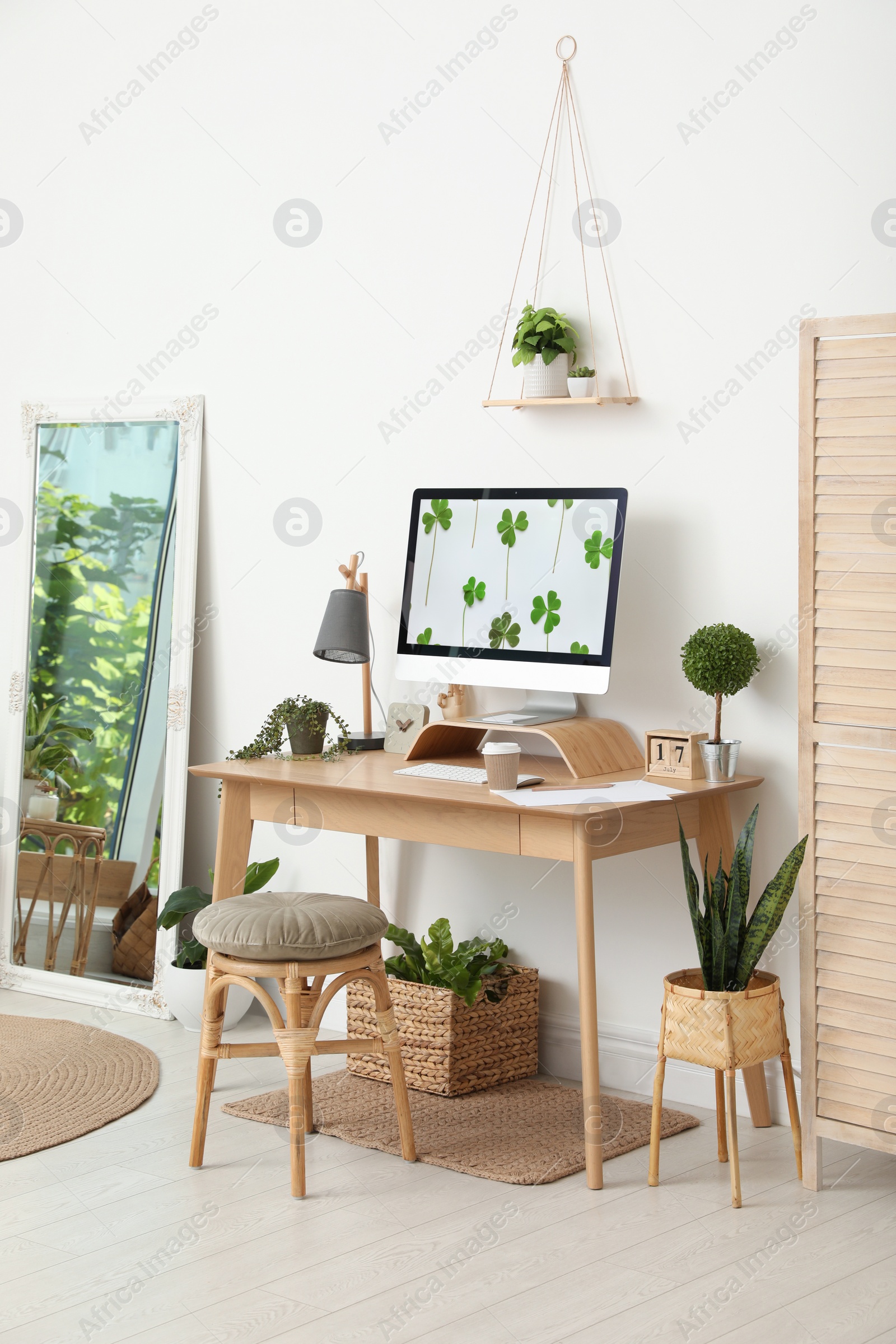 Photo of Stylish room interior with comfortable workplace. Home office