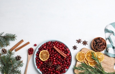 Photo of Flat lay composition with fresh ripe cranberries on white wooden table. Space for text