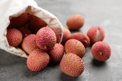 Photo of Fresh ripe lychee fruits on grey table