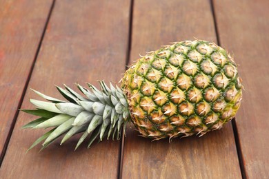Photo of Delicious ripe pineapple on wooden table. Exotic fruit