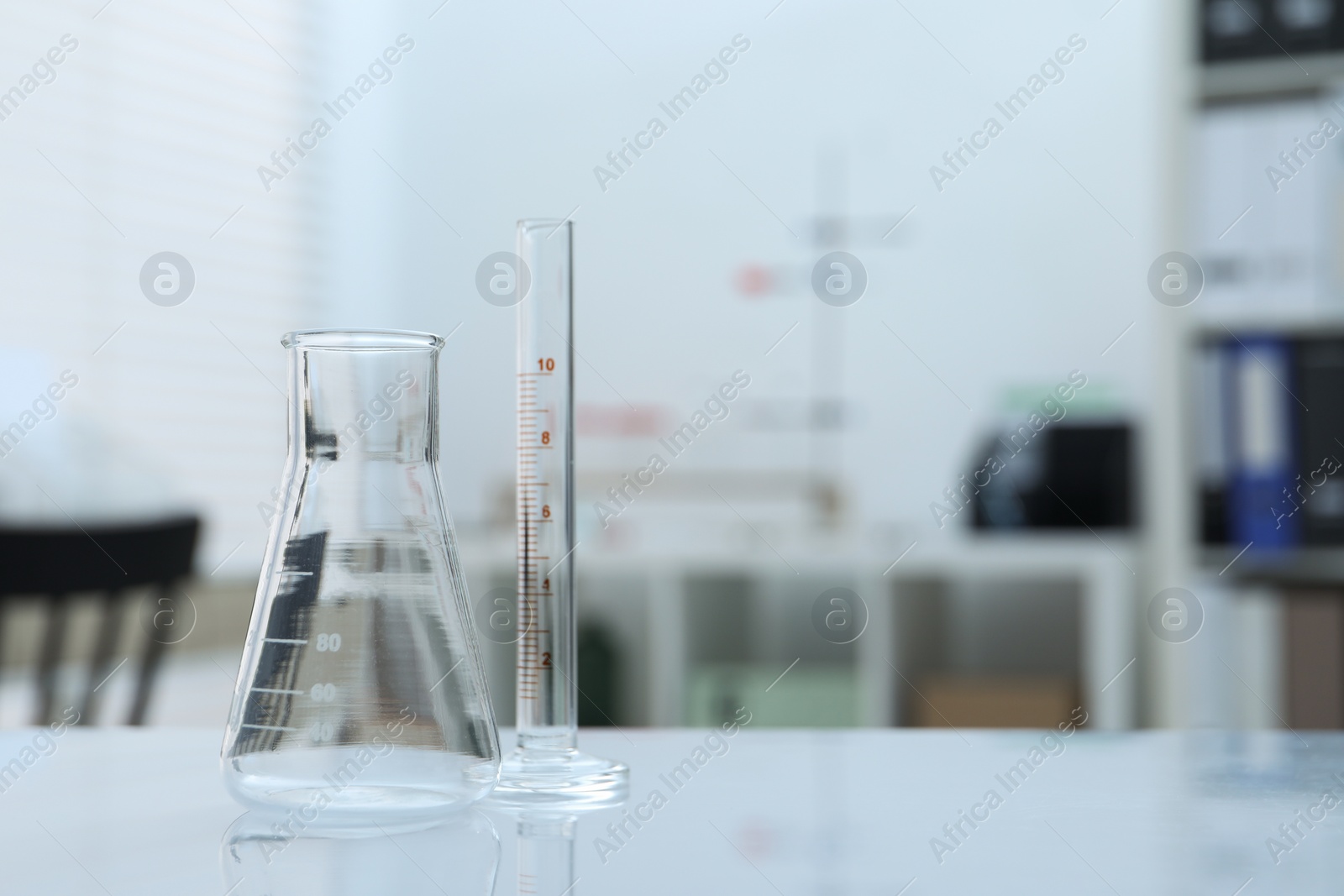 Photo of Laboratory analysis. Flask and test tube on table indoors, space for text