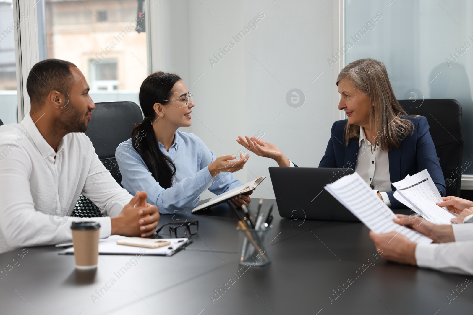 Photo of Lawyers working together at table in office