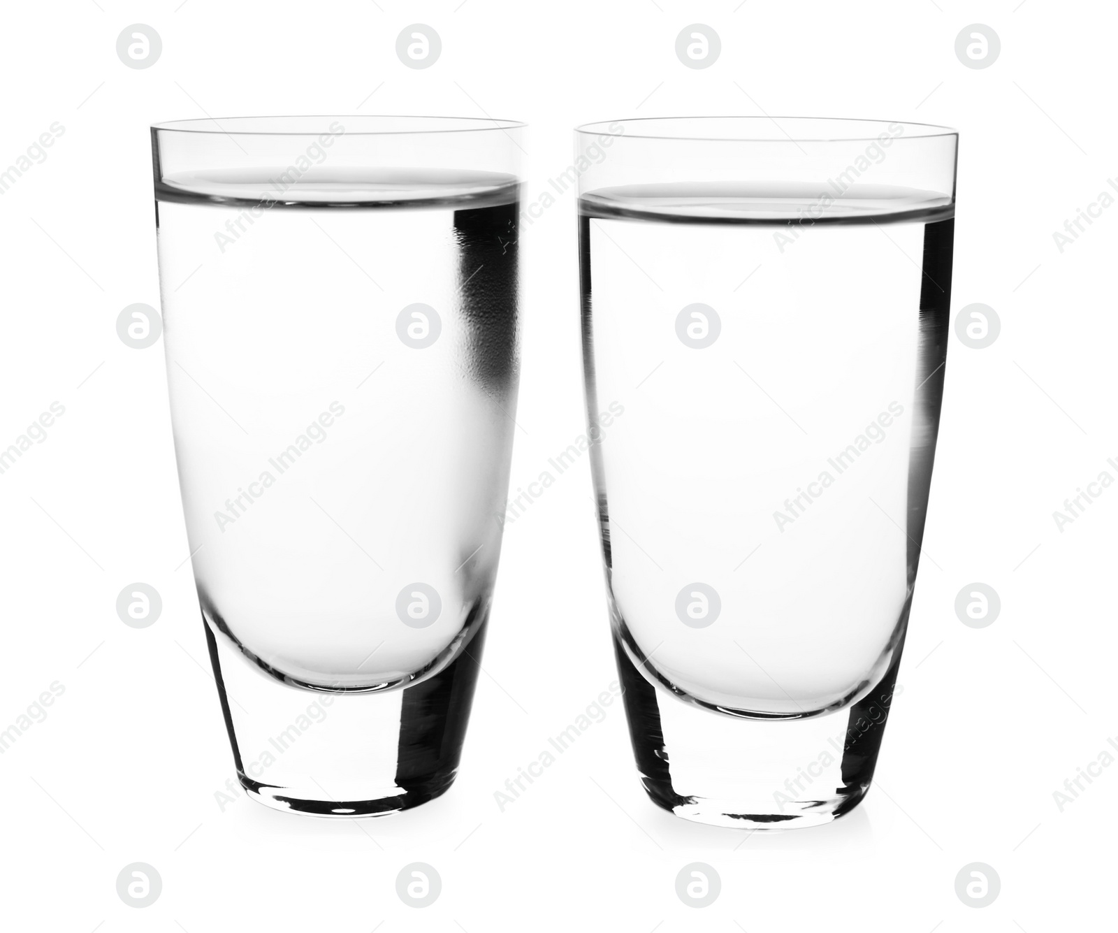 Photo of Cold vodka in shot glasses on white background