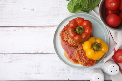 Photo of Delicious stuffed bell peppers on white wooden table, flat lay. Space for text