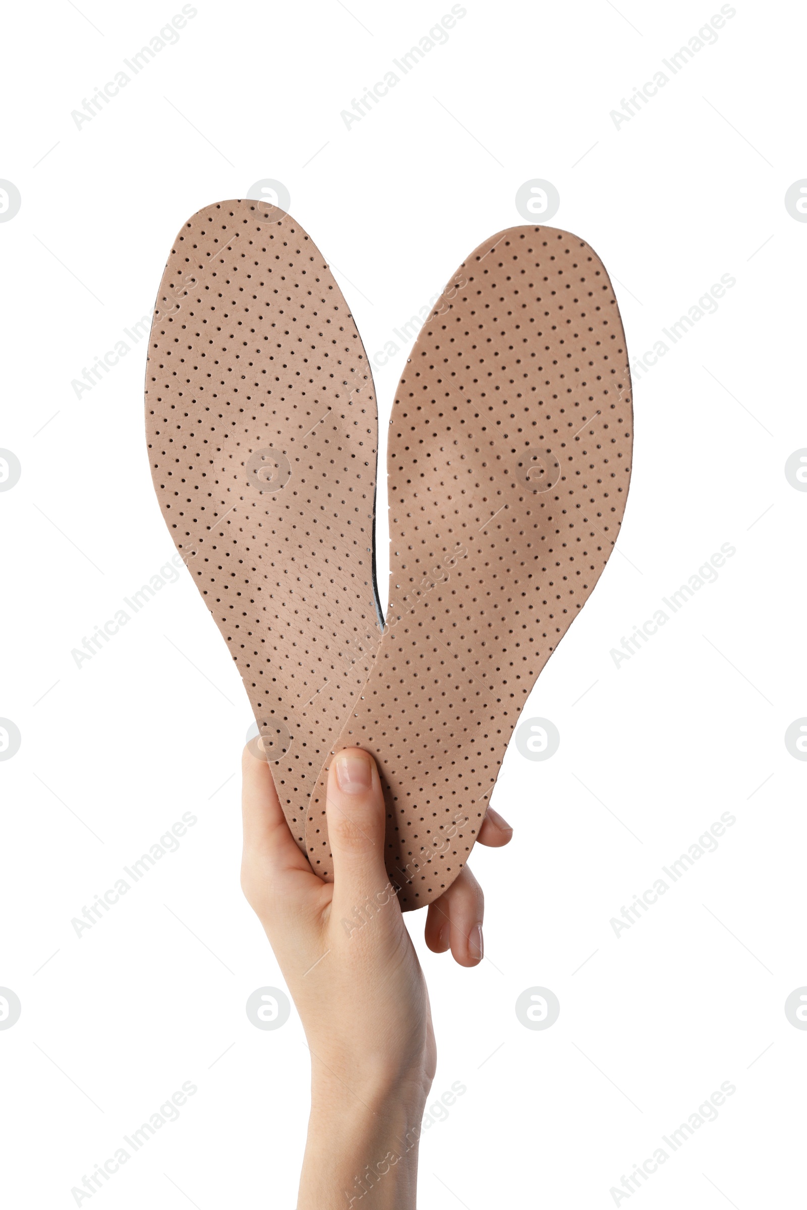 Photo of Woman holding pair of pink orthopedic insoles on white background, closeup